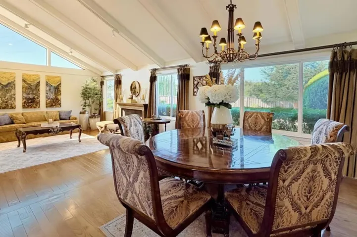 Formal dining area with vaulted ceiling and abundant natural light.