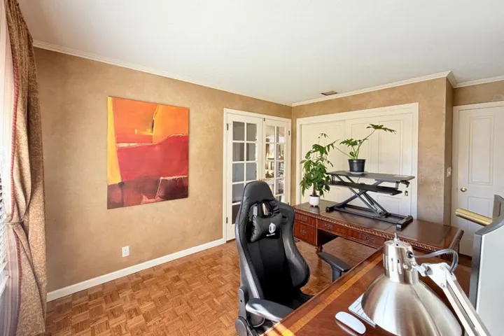 Home office with built-in shelving and natural light.