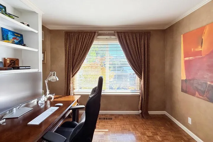 Home office with built-in shelving and natural light.