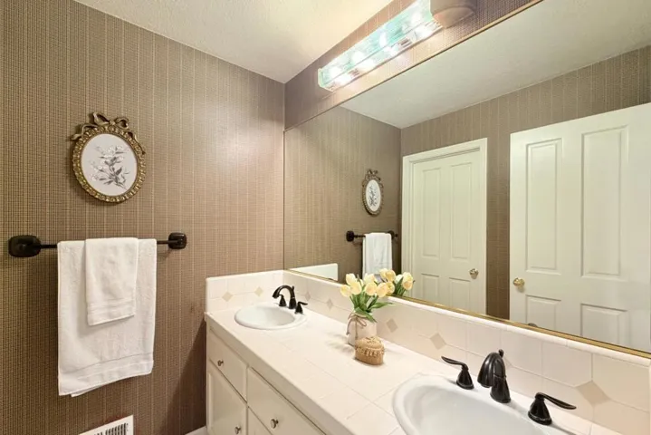 Bathroom with dual-sink vanity.