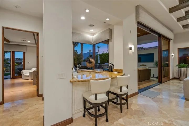 Wet bar with mini-fridge and seating