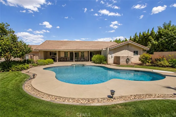 Sunny poolside retreat with landscaped garden