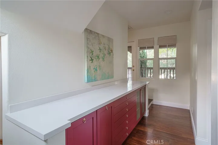 A view of the custom cabinetry and hallway.  To the right are the two Jack and Jill bedrooms and bath.  To the right is the primary suite.