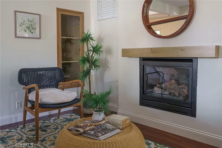 Custom wood and glass bookcase in the corner of the living room.