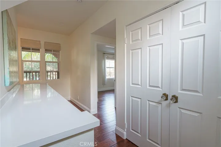Landing at the top of the stairs there is the laundry and custom cabinetry in the hallway.