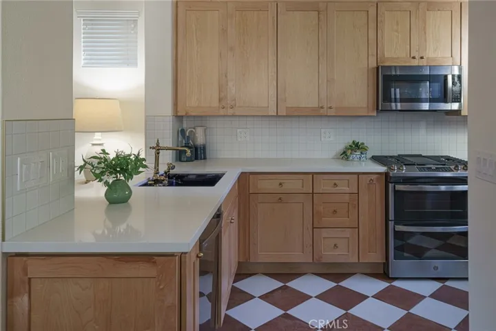 Competely remodeled kitchen with custom cabinets, new appliances, terracotta and cream floor tiles.  This kitchen feels modern and on trend but will never go out of style.