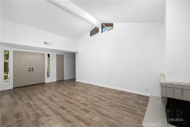Spacious living space with vaulted ceiling.