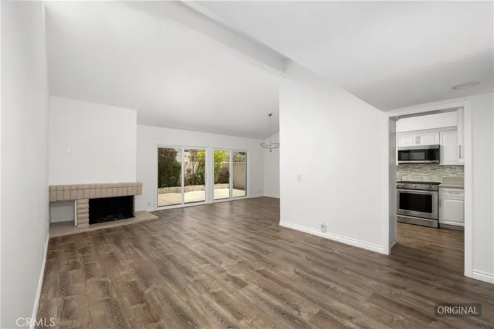 Spacious living area with vaulted ceiling.