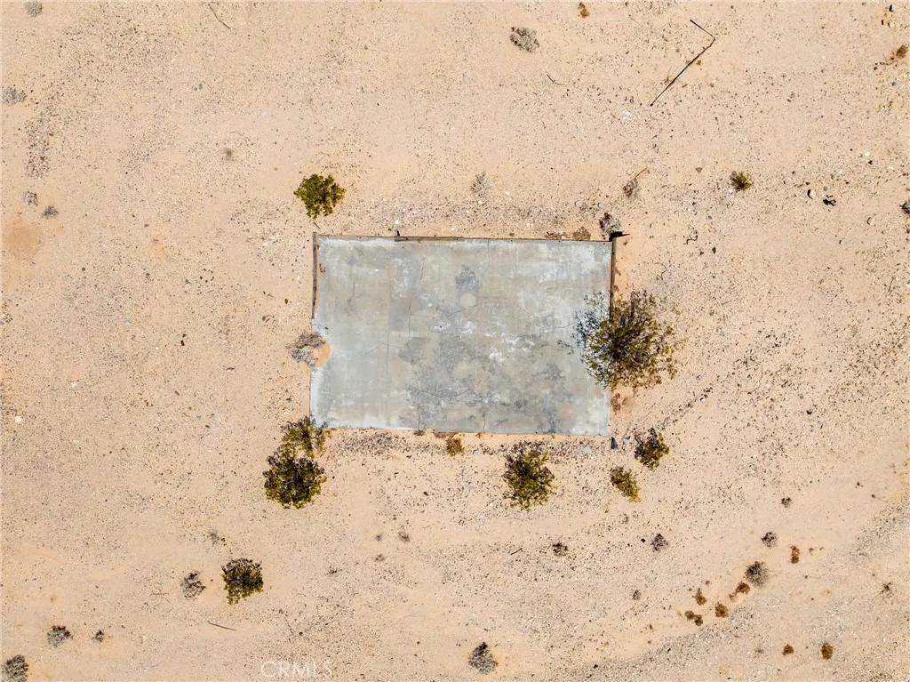 Overhead drone capture showcasing local historic features, a concrete slab from a previous structure, and clear site layout options.