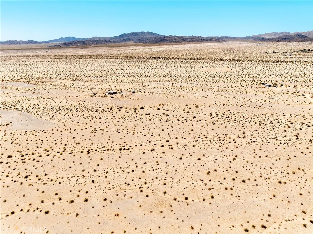 Panoramic landscape drone view demonstrating the easy road accessibility and close proximity to neighboring developments.