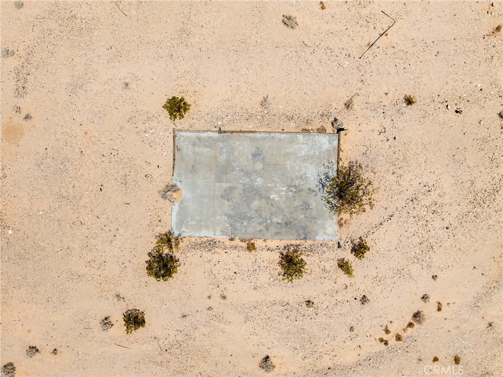 Overhead drone capture showcasing local historic features, a concrete slab from a previous structure, and clear site layout options.