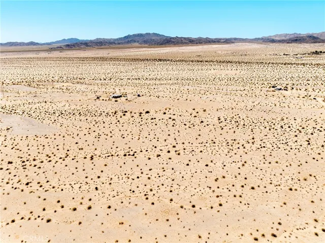 Panoramic landscape drone view demonstrating the easy road accessibility and close proximity to neighboring developments.