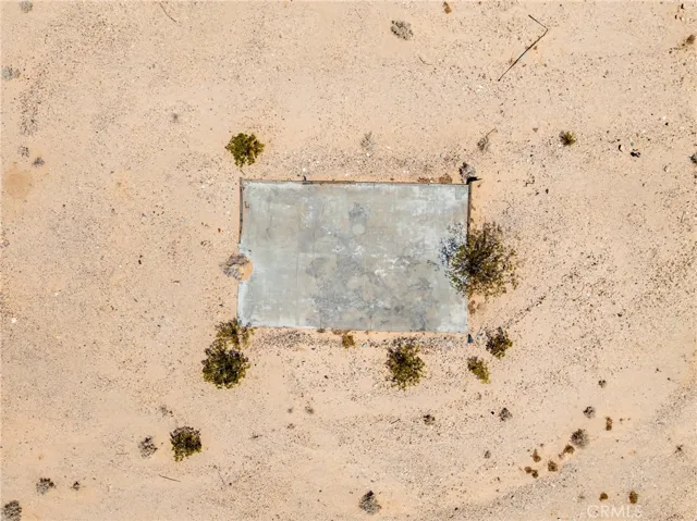 Overhead drone capture showcasing local historic features, a concrete slab from a previous structure, and clear site layout options.