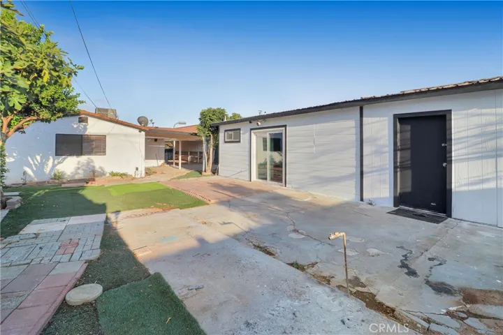 Side of Garage with Separate Entry Into Additional Garage Back Room
