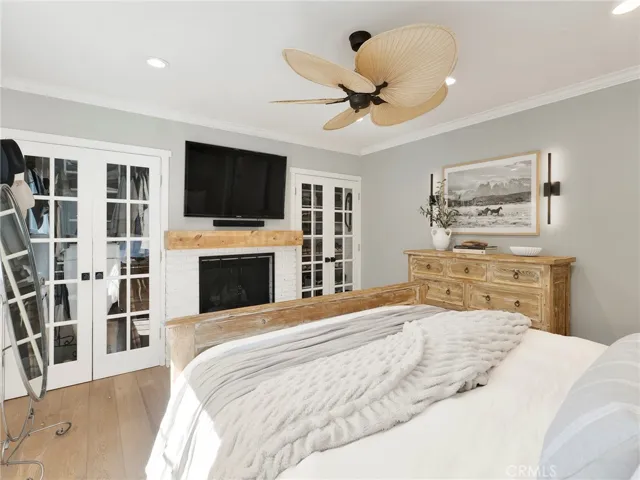 Primary Bedroom with a Cozy Fireplace and Closets