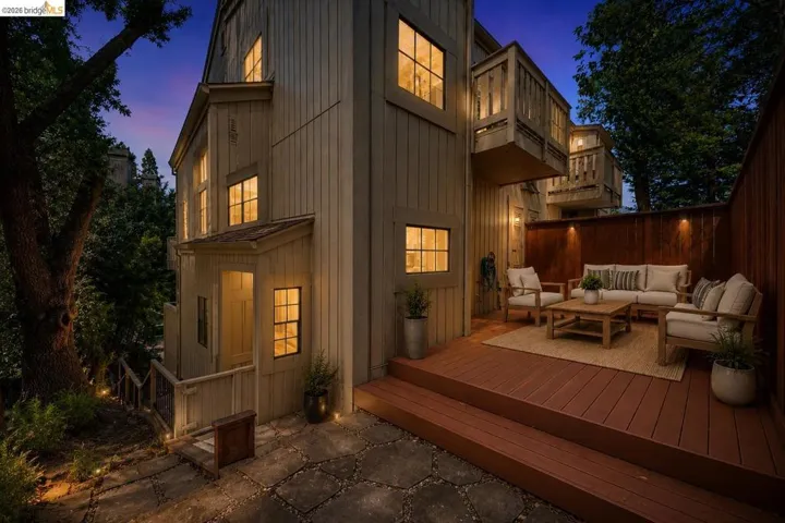 Exterior siding featuring multiple windows with illuminated interiors