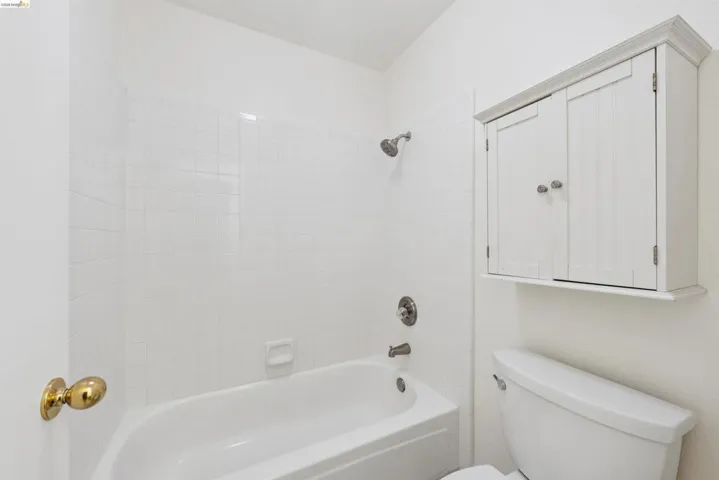 Bathtub with white subway tile surround and brushed nickel fixtures