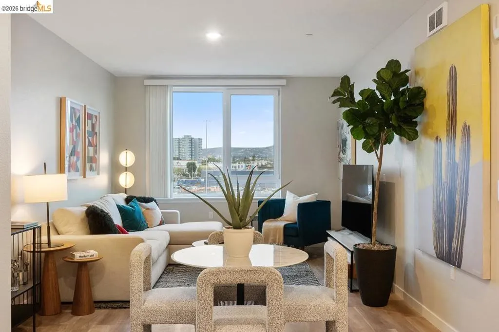 Living area with light wood-style floors and baseboards