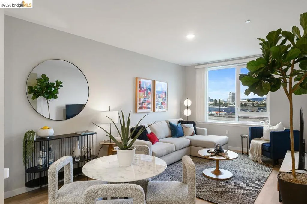 Living room with wood finished floors, recessed lighting, and a city view
