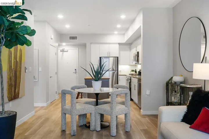 Dining room with light wood-type flooring and recessed lighting
