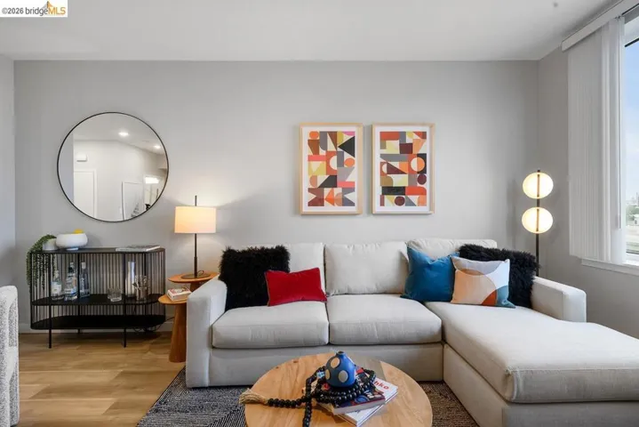 Living area with wood finished floors and healthy amount of natural light