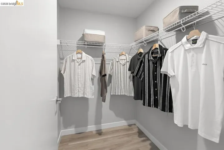 Walk-in closet featuring wire shelving and hanging rods