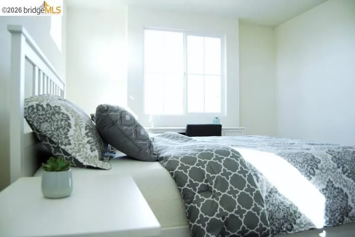 Bright interior space featuring a double-paned window, neutral wall paint, white trim, and a built-in white vanity desk
