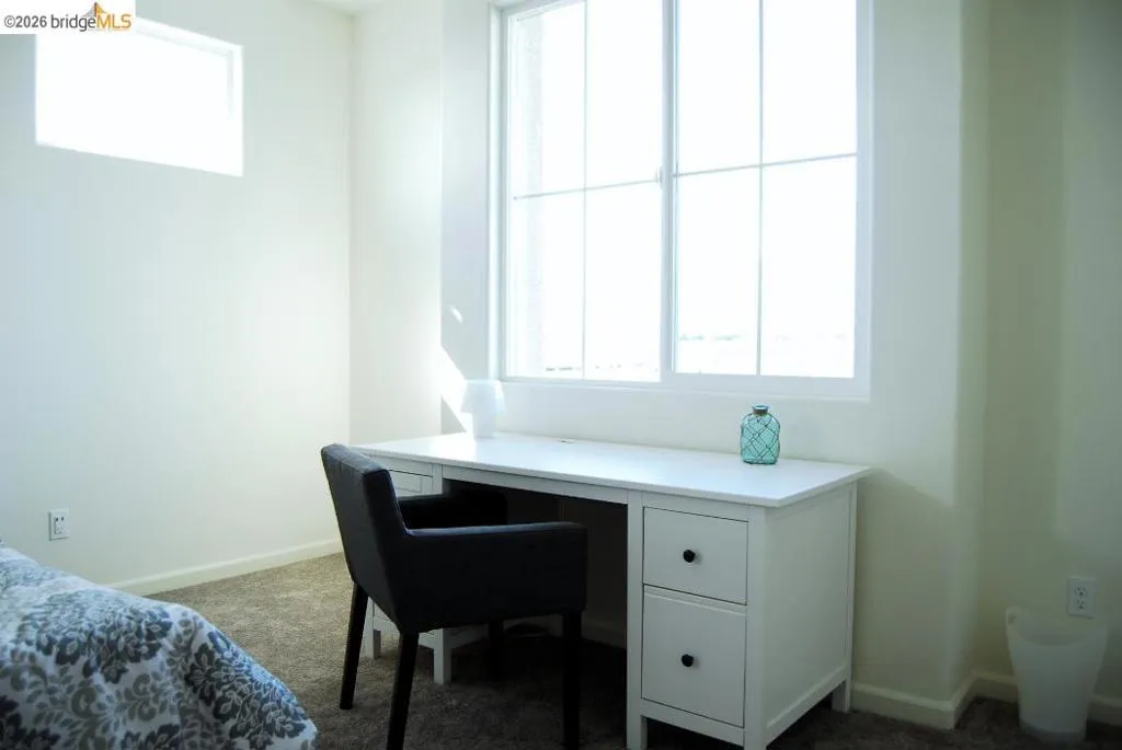 Room featuring a large multi-pane window and a high rectangular window