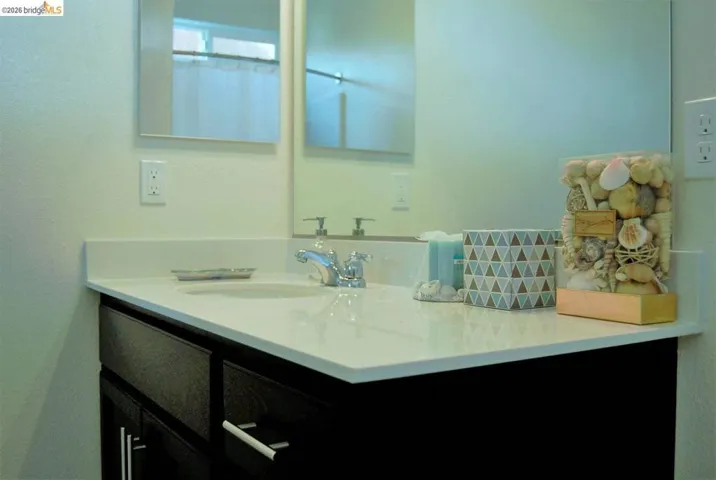 White countertop vanity with an integrated sink and chrome faucet