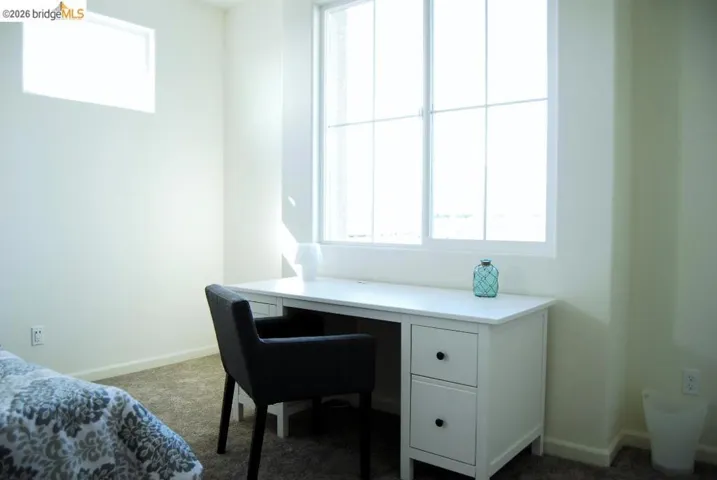 Room featuring a large multi-pane window and a high rectangular window