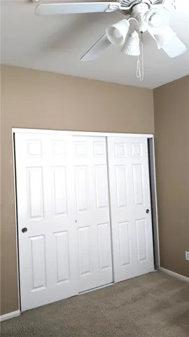 3rd bedroom with 6-panel closet doors & ceiling fan