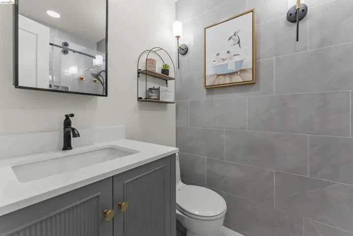 Vanity with integrated sink, matte black faucet, and white countertop