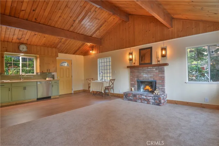 Cozy fireplace in family room with open concept with kitchen and eating area Fire is Photo shopped in