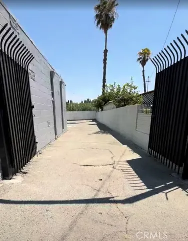 Black metal gate that leads to parking lot