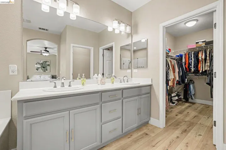 Bathroom featuring a double vanity with light gray cabinetry and white countertops