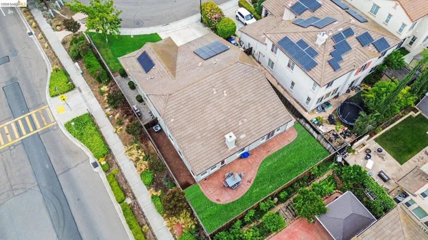 Aerial perspective showcasing a property with a tile roof and visible solar panels