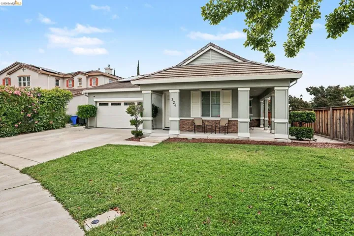 Single-story residence featuring a covered front porch with stone accents, a two-car garage, and a concrete driveway