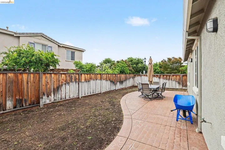 Expansive outdoor patio area featuring a stamped concrete surface and a curved perimeter