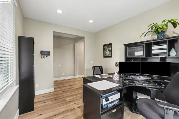 Room featuring wood-finish flooring, recessed lighting, and light-toned wall paint