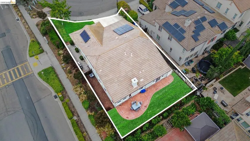 Aerial perspective showcasing a property with a tile roof and integrated solar panels