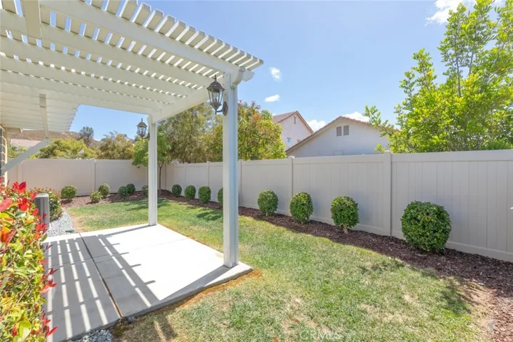 Beautiful Landscaped Backyard with a Lattice Patio Cover.