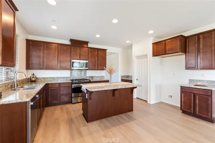Gourmet Kitchen with SS Appliances, Granite Countertops, Center Island and Walk-in Pantry.