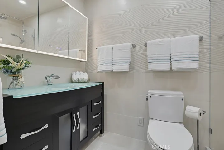 Medicine cabinet with luminated mirror and defogging.