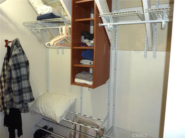 Built in wood shelves in the master bedroom closet.