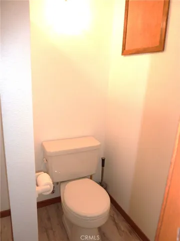 The pony wall separates the toilet from the sink in the master bathroom.
