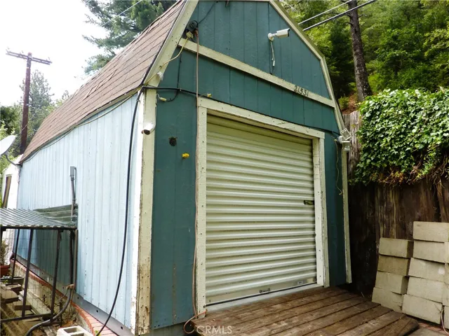 This is the rear of the storage shed in front of the home with the garage door closed.
