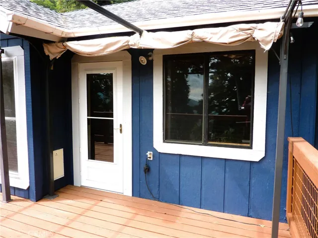 The main deck on the upper level is just off the living area of the home and features some awning for shade from the warm sun.
