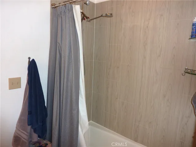 The shower in the tub in the master bathroom.
