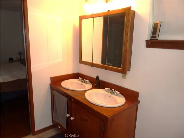 The master bathroom has a double sink with wood counter top.