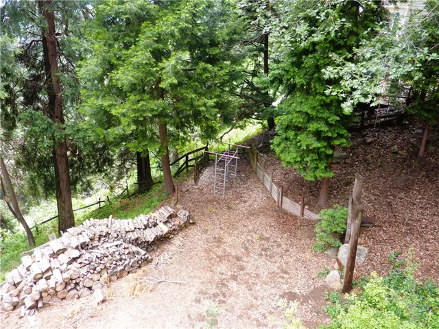 From the rear deck, you can see the level yard and the swing set.